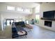 Bright living room with white brick walls, large windows, fireplace, and contemporary furnishings at 5801 E Surrey Dr, Cave Creek, AZ 85331