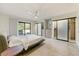 Bright bedroom with white brick walls, access to the outdoors, and large closets with sleek sliding doors at 5801 E Surrey Dr, Cave Creek, AZ 85331