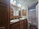 Bathroom featuring double sinks, wood cabinets and a glass-enclosed shower at 650 N Hawes Rd # 3604, Mesa, AZ 85207