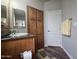 Bathroom featuring a single sink vanity, and a tall, wooden cabinet with paneled doors at 650 N Hawes Rd # 3604, Mesa, AZ 85207