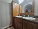 Bathroom featuring a double sink vanity, wooden cabinets, and a large mirror at 650 N Hawes Rd # 3604, Mesa, AZ 85207