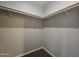 Walk-in closet with a neutral wall and carpet, featuring a wooden rod and shelf storage system at 650 N Hawes Rd # 3604, Mesa, AZ 85207