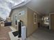 Exterior side view of the home with a water softener and covered carport at 650 N Hawes Rd # 3604, Mesa, AZ 85207