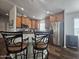 Spacious kitchen with stainless appliances, wood cabinets, and breakfast bar at 650 N Hawes Rd # 3604, Mesa, AZ 85207