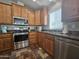 Updated kitchen featuring stainless steel appliances, wood cabinets, and tile flooring at 650 N Hawes Rd # 3604, Mesa, AZ 85207