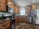 A kitchen featuring stainless steel appliances, lots of counter space and hard wood cabinetry at 650 N Hawes Rd # 3604, Mesa, AZ 85207