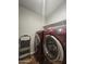 A laundry room with a red washer and dryer and a silver step ladder at 650 N Hawes Rd # 3604, Mesa, AZ 85207