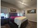 Bright bedroom with a ceiling fan, neutral walls, and a queen bed with burgundy and navy bedding at 650 N Hawes Rd # 3604, Mesa, AZ 85207