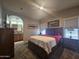 Comfortable bedroom featuring a queen bed, with nightstands, lamps and en suite bathroom with double sinks at 650 N Hawes Rd # 3604, Mesa, AZ 85207
