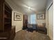 Home office featuring neutral carpet, a ceiling fan and a dark wood desk with matching bookshelves at 650 N Hawes Rd # 3604, Mesa, AZ 85207