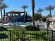 Community pool and clubhouse, surrounded by lounge chairs and palm trees at 650 N Hawes Rd # 3604, Mesa, AZ 85207