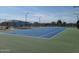 Outdoor tennis courts with blue playing surface, fencing, and lighting for community play at 650 N Hawes Rd # 3604, Mesa, AZ 85207