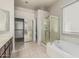 Bathroom featuring a glass shower, soaking tub, and ample counter space at 7130 E Laguna Azul Ave, Mesa, AZ 85209