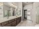 Well-lit bathroom with double sinks, dark cabinets, and a walk-in shower at 7130 E Laguna Azul Ave, Mesa, AZ 85209