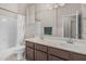 Bathroom featuring dual sinks, a vanity with a mirror, and a bathtub with a shower at 7130 E Laguna Azul Ave, Mesa, AZ 85209