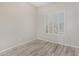 This bedroom has a ceiling fan, a window with shutters and wood-style flooring at 7130 E Laguna Azul Ave, Mesa, AZ 85209