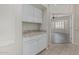 Convenient butler's pantry with granite countertop and white cabinetry, ideal for extra storage at 7130 E Laguna Azul Ave, Mesa, AZ 85209