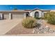 Charming single-story home with well-maintained landscaping and a three-car garage at 7130 E Laguna Azul Ave, Mesa, AZ 85209