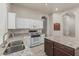 Bright kitchen featuring white cabinets, granite countertops, and stainless steel appliances at 7130 E Laguna Azul Ave, Mesa, AZ 85209
