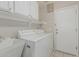 The laundry room features a utility sink, storage cabinets, a washer, and a dryer at 7130 E Laguna Azul Ave, Mesa, AZ 85209