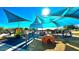 Community playground with slides, climbing structures, and shade canopies, perfect for Gathering fun in the sun at 7130 E Laguna Azul Ave, Mesa, AZ 85209