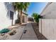 Charming side yard features stone landscaping and a concrete walkway to the gated entrance at 7130 E Laguna Azul Ave, Mesa, AZ 85209