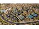 Aerial view of a community with swimming pools, tennis courts, parking lots, and desert landscaping at 7413 E Russet Sky Dr, Scottsdale, AZ 85266
