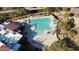 Aerial view of community pool surrounded by desert landscaping, seating and sunbathers at 7413 E Russet Sky Dr, Scottsdale, AZ 85266