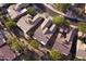 Aerial view of a neighborhood showcasing well-maintained homes with tile roofs and mature trees at 7413 E Russet Sky Dr, Scottsdale, AZ 85266