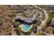 Stunning aerial view of community pool, clubhouse, and tennis courts in a beautiful, upscale neighborhood at 7413 E Russet Sky Dr, Scottsdale, AZ 85266