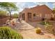 Backyard featuring an inviting covered patio, outdoor seating, and unique desert landscaping elements at 7413 E Russet Sky Dr, Scottsdale, AZ 85266