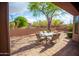 Backyard featuring a brick patio and comfortable seating area with desert landscaping at 7413 E Russet Sky Dr, Scottsdale, AZ 85266