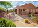 Charming backyard featuring a brick patio, desert landscaping, and a cozy seating area at 7413 E Russet Sky Dr, Scottsdale, AZ 85266