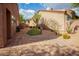 Backyard with brick patio, desert landscaping, and a grill for outdoor cooking at 7413 E Russet Sky Dr, Scottsdale, AZ 85266