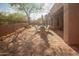 Inviting backyard featuring a tiled patio area, desert landscaping, and a cozy seating arrangement at 7413 E Russet Sky Dr, Scottsdale, AZ 85266