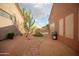 Desert backyard featuring drought-tolerant landscaping, decorative rocks, and a brick-paved walkway at 7413 E Russet Sky Dr, Scottsdale, AZ 85266