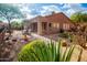 Charming backyard with a brick patio, desert landscaping and comfortable seating area at 7413 E Russet Sky Dr, Scottsdale, AZ 85266