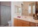 Bathroom featuring wood vanity, mirror, and a shower with a patterned curtain at 7413 E Russet Sky Dr, Scottsdale, AZ 85266