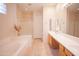 Bright bathroom featuring a garden tub, glass-enclosed shower, and double sink vanity at 7413 E Russet Sky Dr, Scottsdale, AZ 85266