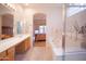 Spacious bathroom featuring double sinks, separate glass shower, and soaking tub at 7413 E Russet Sky Dr, Scottsdale, AZ 85266