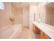 Bright bathroom featuring double sinks, separate glass shower, and soaking tub at 7413 E Russet Sky Dr, Scottsdale, AZ 85266