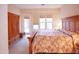 Bedroom with large bed, wardrobe, door to backyard, and bright windows at 7413 E Russet Sky Dr, Scottsdale, AZ 85266