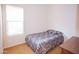 Simple bedroom with a full bed, carpet, and natural light streaming through a window at 7413 E Russet Sky Dr, Scottsdale, AZ 85266