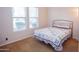 Bedroom featuring carpet, a queen-sized bed with a patterned quilt, and large windows at 7413 E Russet Sky Dr, Scottsdale, AZ 85266