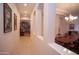 Hallway leading to dining room and library, filled with natural light and elegant archways at 7413 E Russet Sky Dr, Scottsdale, AZ 85266