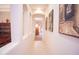 Hallway with decorative art niches leading to dining area at 7413 E Russet Sky Dr, Scottsdale, AZ 85266