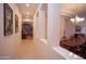 Hallway featuring decorative archways and views of the formal dining room and library at 7413 E Russet Sky Dr, Scottsdale, AZ 85266