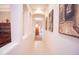 Hallway with decorative wall niches featuring art and a view into the home at 7413 E Russet Sky Dr, Scottsdale, AZ 85266