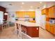 Well-lit kitchen with island, breakfast bar, and ample cabinet space at 7413 E Russet Sky Dr, Scottsdale, AZ 85266