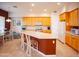 Bright eat-in kitchen features a large island, lots of cabinet storage, and tile floors at 7413 E Russet Sky Dr, Scottsdale, AZ 85266